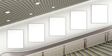 Blank advertising poster on underground escalator wall 