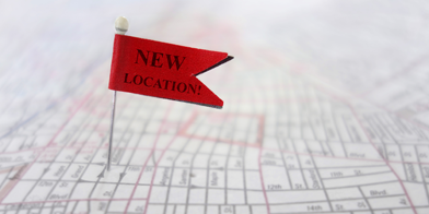 Closeup of a New Location pin flag on a map